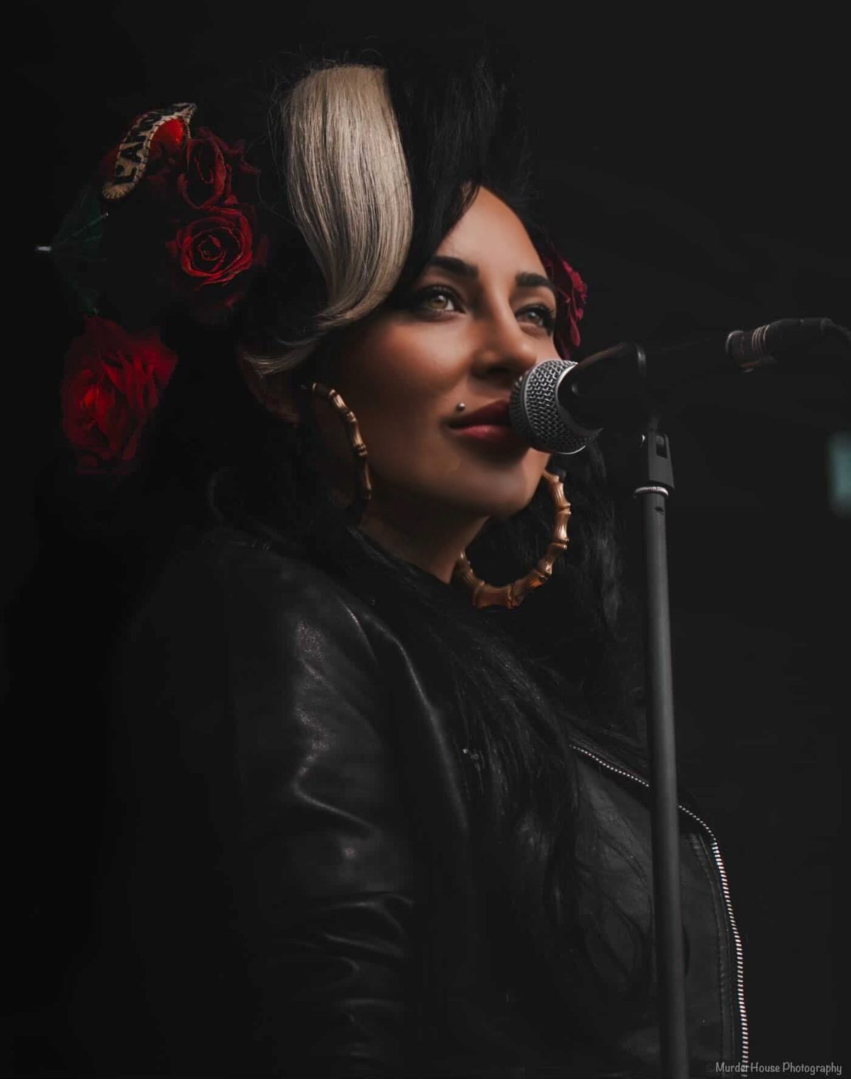 Nadine L’Amour singing live in the signature beehive and red roses